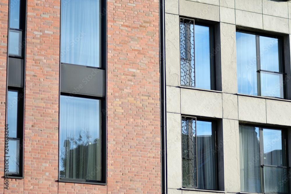 Modern apartment buildings on a sunny day with a blue sky. Facade of a modern apartment building Modern apartment buildings on a sunny day with a blue sky. Facade of a modern apartment building