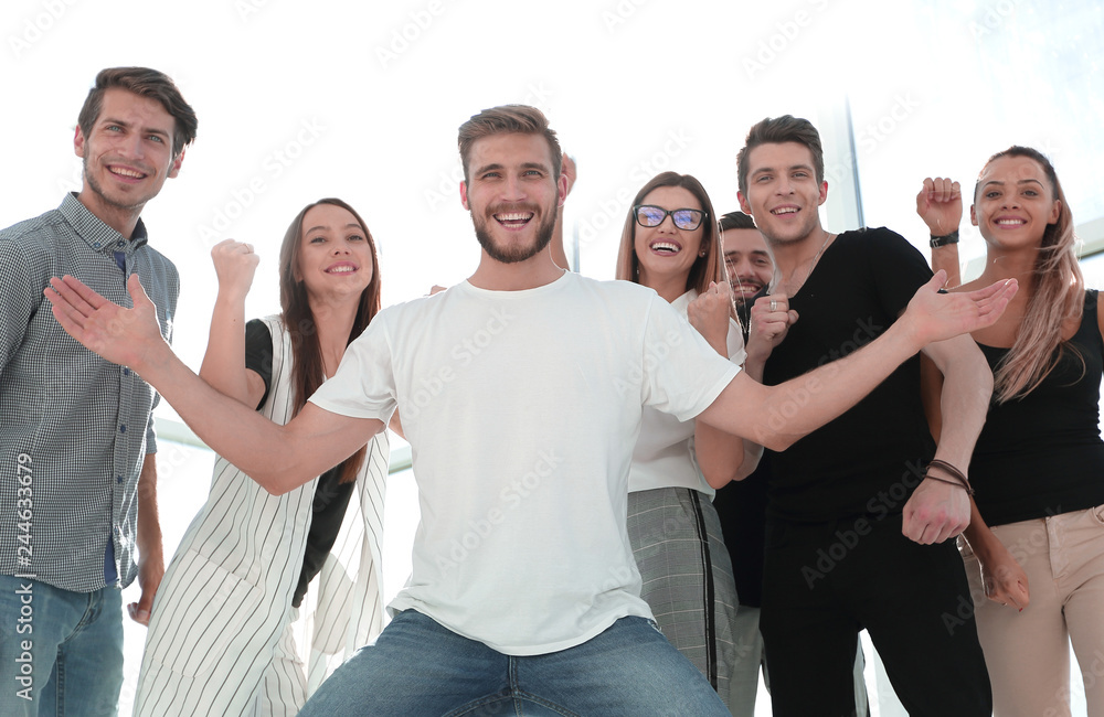 happy guy standing in front of the business team