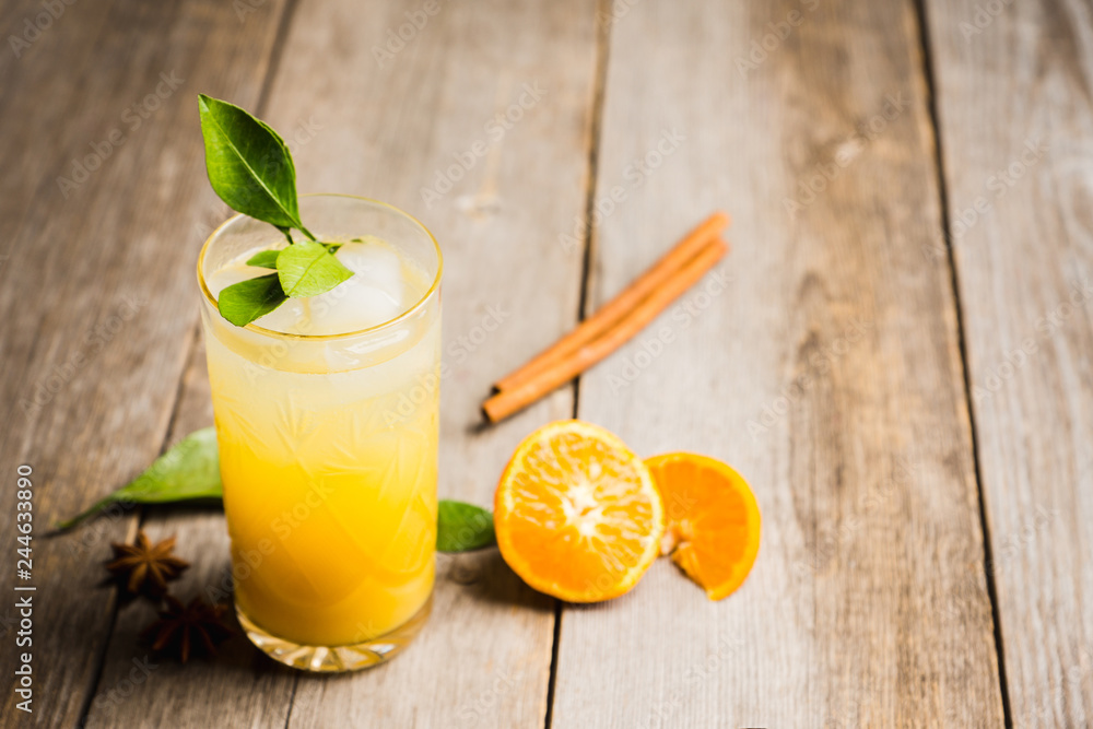 Fototapeta premium Fresh cocktail with mandarines on the rustic background. Selective focus. Shallow depth of field.