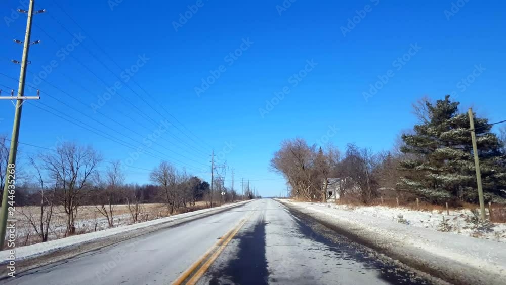 Driving Winter Rural Road in Day. Driver Point of View POV Countryside Street With Snow in Daytime. Driving Winter Rural Road in Day. Driver Point of View POV Countryside Street With Snow in Daytime.