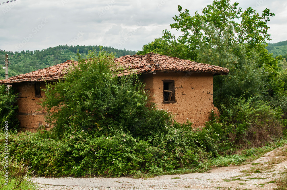 Fototapeta premium Old abandoned weathered retro vintage rural brick wall house