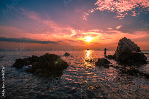 The background of the sea by the evening sea  with natural beauty  sea water  rocks  sky  and fishermen are fishing by the river bank  is a pleasure during travel.