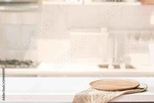 Wood plate on white table in kitchen room background and copy spce for productor food montage photo