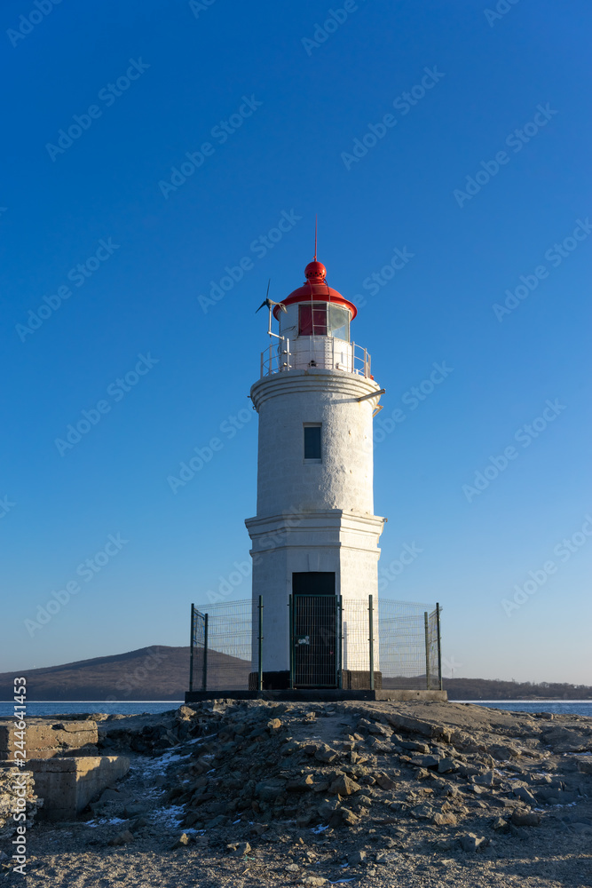 Seascape overlooking The Tokarev lighthouse against the blue sky.