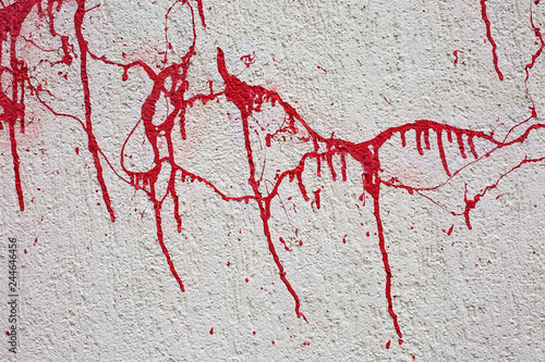 Background texture wall with red blood like paint streaks.