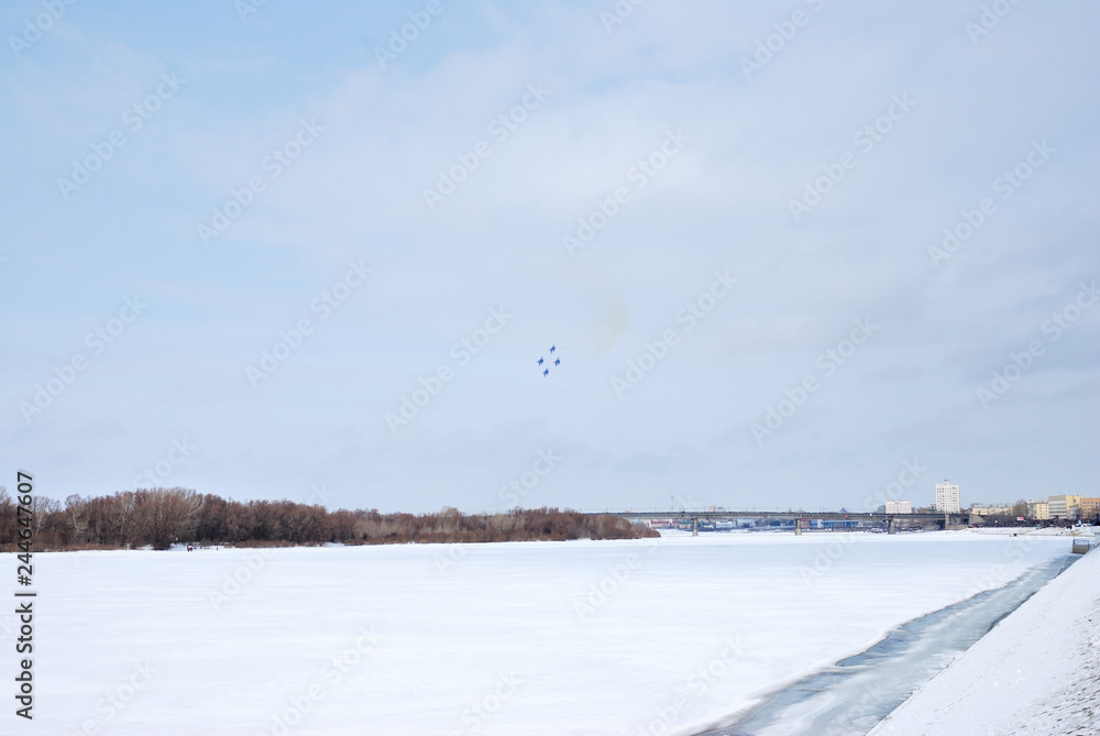 Performance of aerobatic team Russian Knights at the air show..Omsk, Russia - 19 March, 2016: Performance of Russian Knights at the air show..