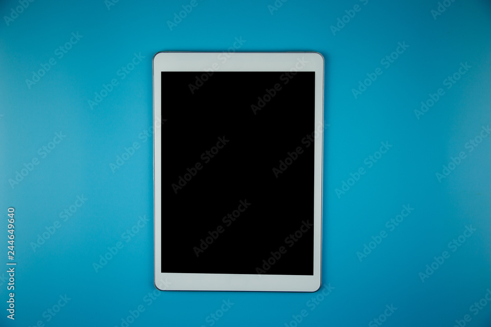 top view with blank mock up tablet on Office desk working space. top view with blank mock up tablet on Office desk working space.