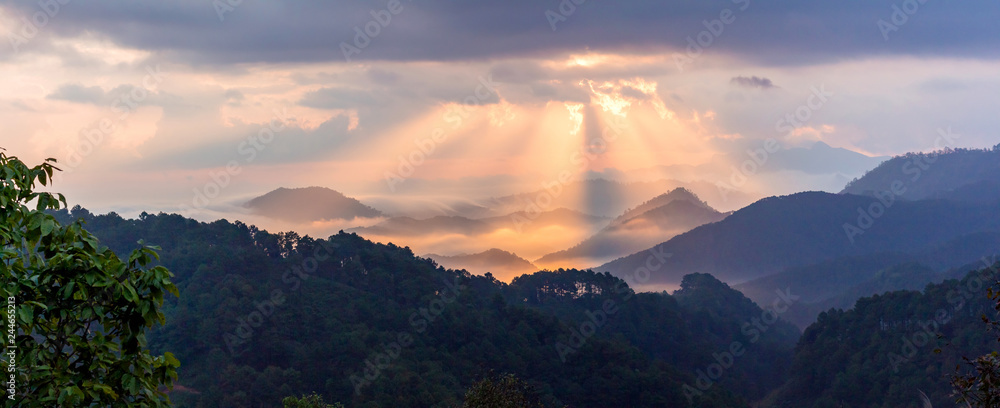 Sun's rays with colorful of sky in the evening or morning at famous mountain in Thailand