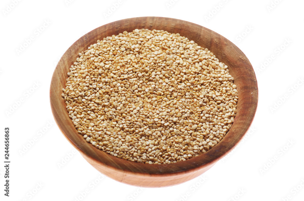 Raw organic superfood gluten free quinoa seeds in wooden bowl closeup isolated on white background Raw organic superfood gluten free quinoa seeds in wooden bowl closeup isolated on white background