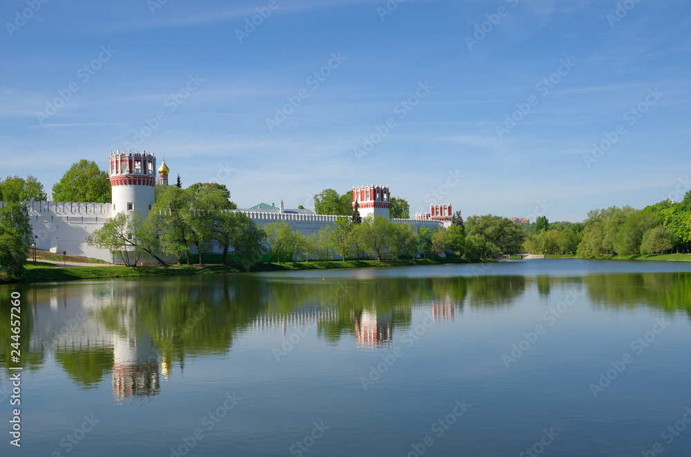 View of the Novodevichy convent from the Big Novodevichy pond on a Sunny spring day. Moscow, Russia