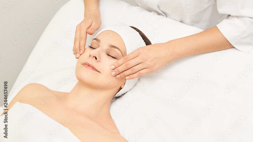 Face professional massage. Spa skincare treatment. Health facial masseur. Girl with doctor hands. Relax cosmetology procedure Face professional massage. Spa skincare treatment. Health facial masseur. Girl with doctor hands. Relax cosmetology procedure