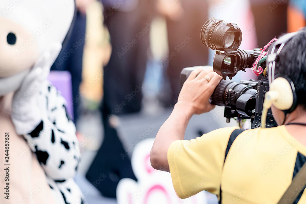 Video camera operator working with his equipment outdoor. Video camera operator working with his equipment outdoor.