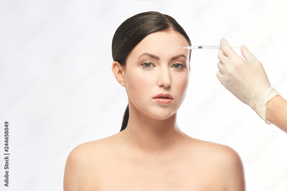 Face needle injection. Young woman cosmetology procedure. Doctor gloves