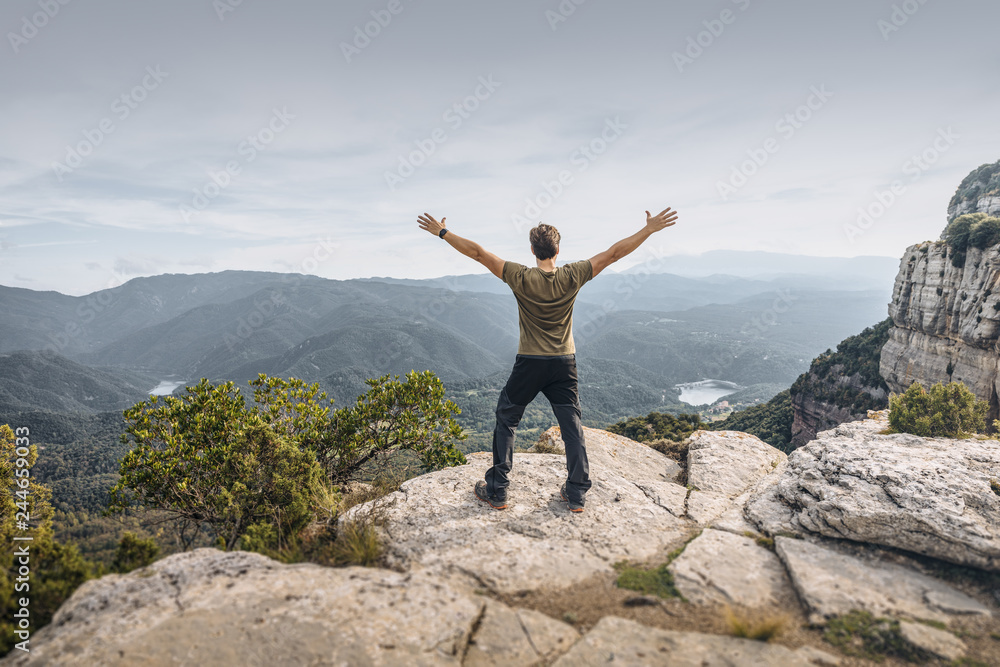 Man showing freedom in the mountain