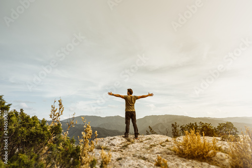 Man showing freedom in the mountain