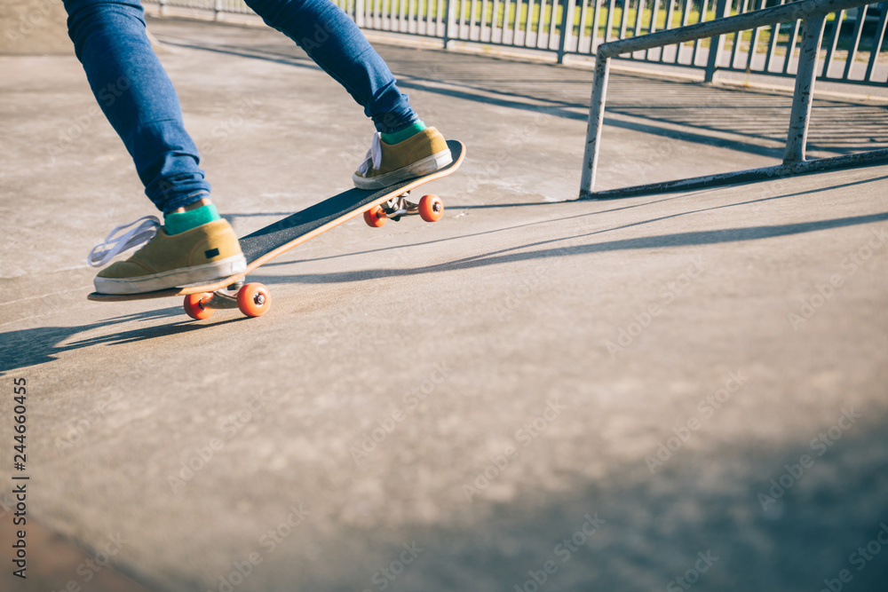 Skateboarder skateboarding at skatepark Skateboarder skateboarding at skatepark