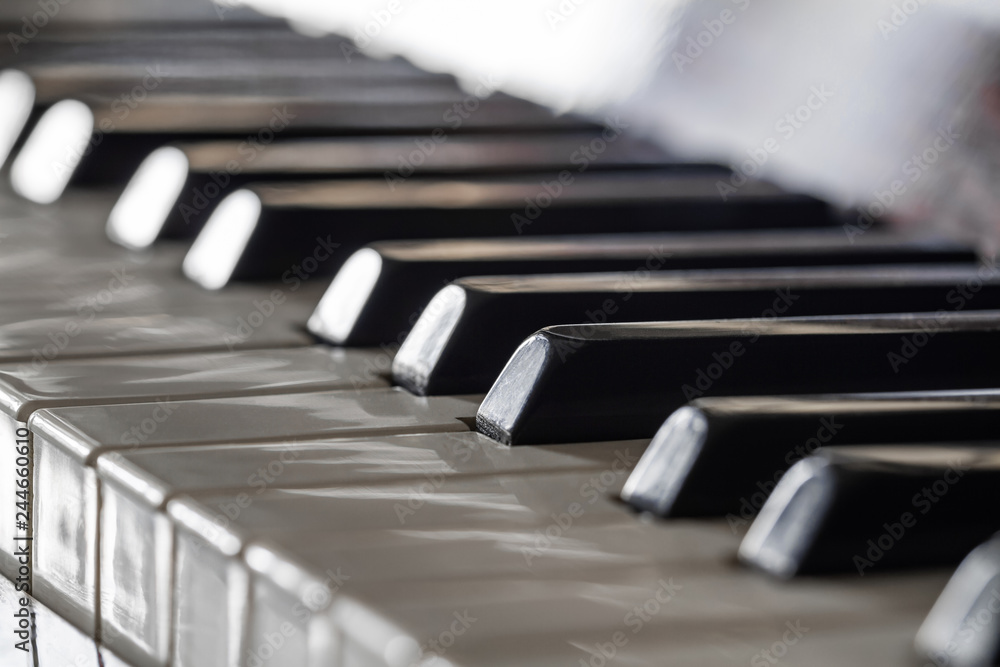 Antique piano keys and wood grain. Closeup, selective focus Antique piano keys and wood grain. Closeup, selective focus