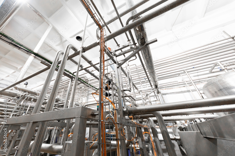 Metallic pipes isolated on factory background Metallic pipes isolated on factory background