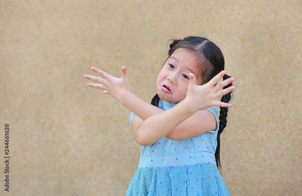 Sassy little Asian kid girl with funny face and expression cross one's arm.  Stock Photo | Adobe Stock