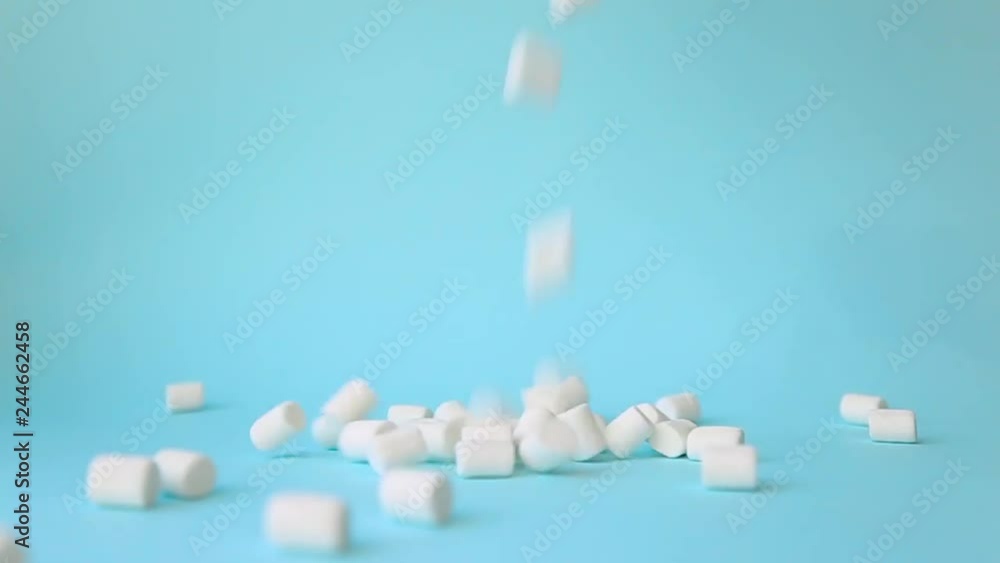 white marshmallows on top of the falling blue background white marshmallows on top of the falling blue background
