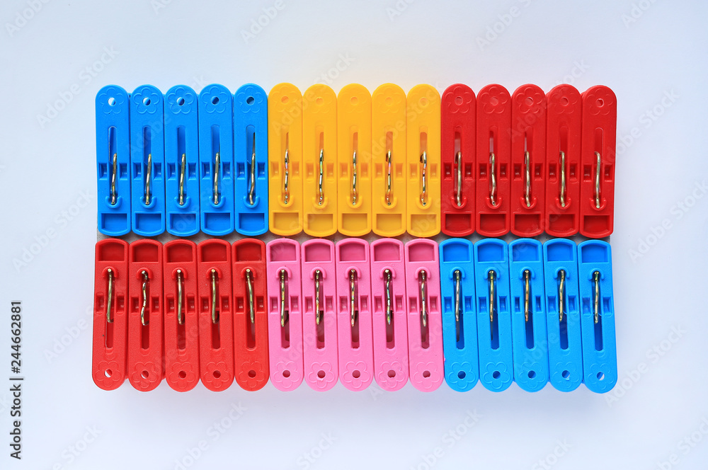 Set of colorful plastic clothespins on white background.
