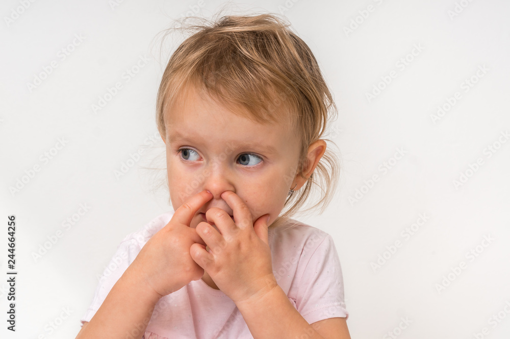 Baby girl is picking her nose with finger inside Baby girl is picking her nose with finger inside