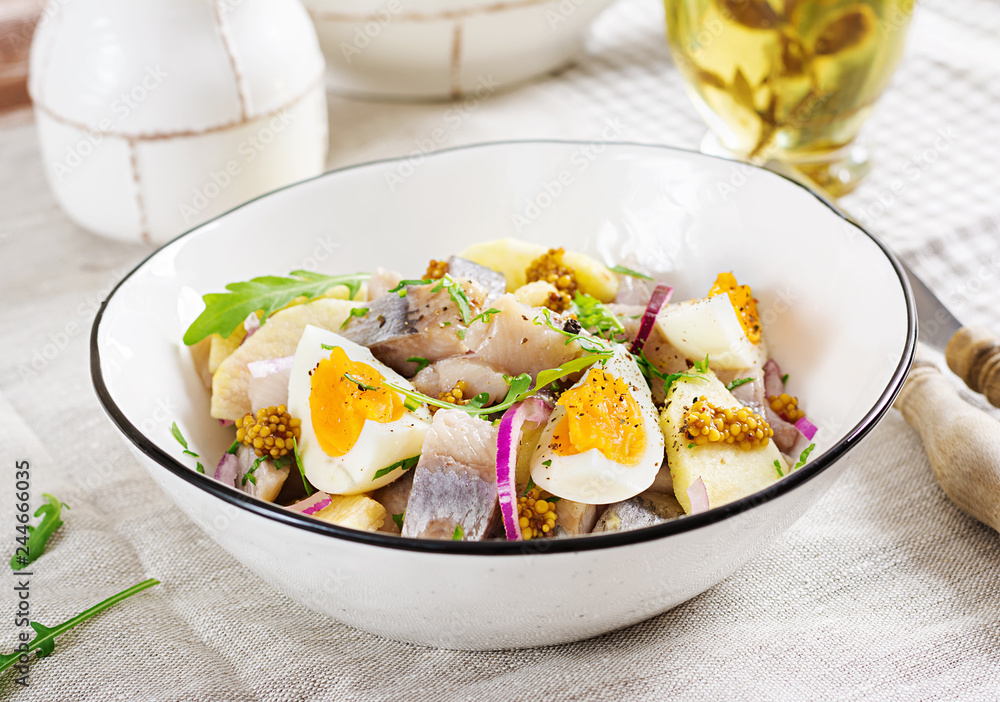 Traditional  salad of salted herring fillet, fresh apples,  red onion  and eggs. Kosher food. Scandinavian cuisine.