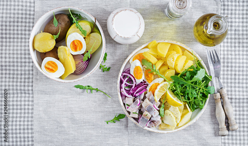 Wallpaper Mural Traditional  salad of salted herring fillet, eggs, fresh apples,  red onion  and potatoes. Kosher food. Scandinavian cuisine. Top view. Flat lay Torontodigital.ca