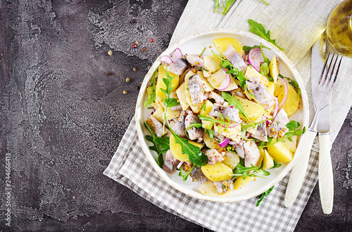 Traditional  salad of salted herring fillet, fresh apples,  red onion  and potatoes. Kosher food. Scandinavian cuisine. Top view. Flat lay photo