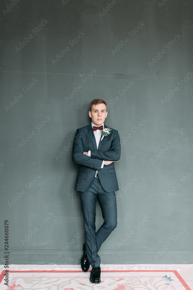 Stylish young groom in a bright Studio. Wedding in the European style fine art. Stylish young groom in a bright Studio. Wedding in the European style fine art.
