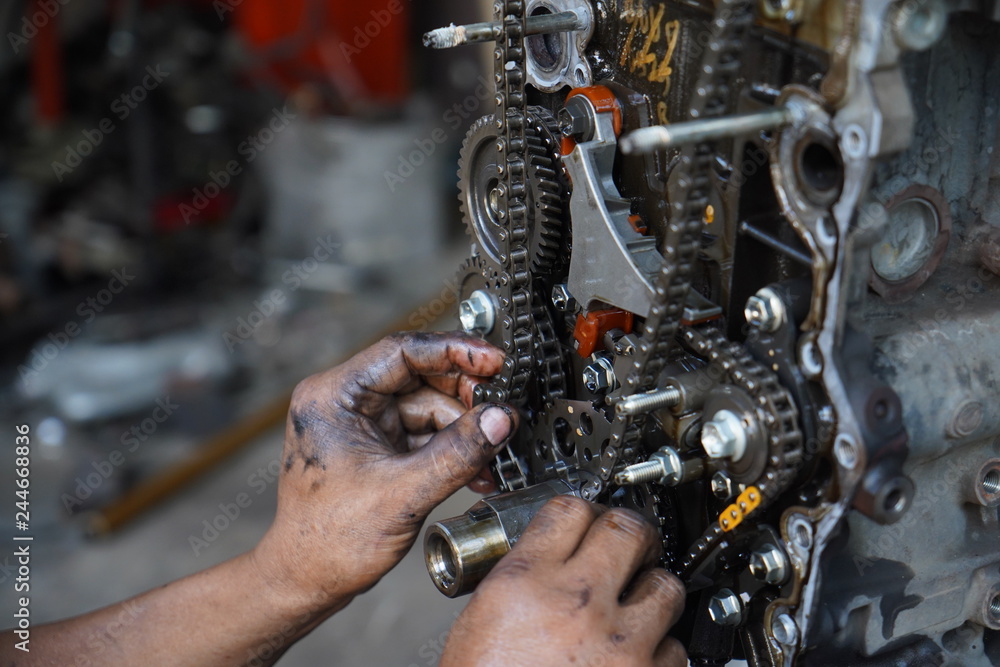 Fototapeta premium Hand working on car's engine