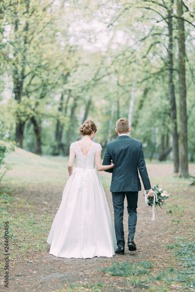 Beautiful young couple in the atmospheric forest. Wedding in the European style fine art.