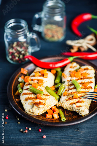 grilled turkey fillet with vegetables, pepper and spices on a plate