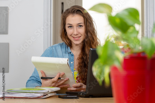 portrait of pretty young woman working at office