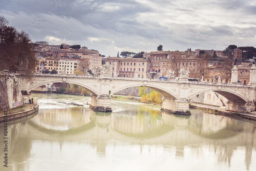 Rome, Italy, December 2018: View of the Tiber river in Rome, Italy ruring overcast day with ancient city architecture