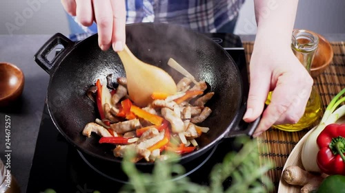 Pork in Sechuan. Preparing dishes on the wok in the kitchen. photo