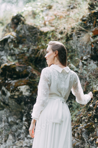 Morning bride on a beautiful panoramic location. Girl in boudoir dress and cliffs.