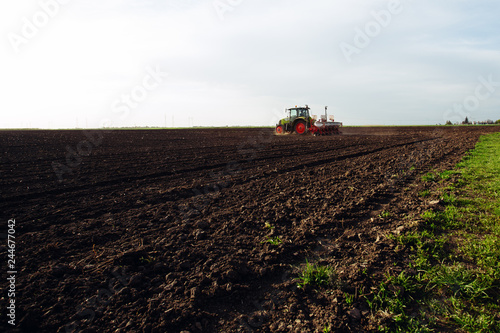 Farmer seeding crops at field. - Image