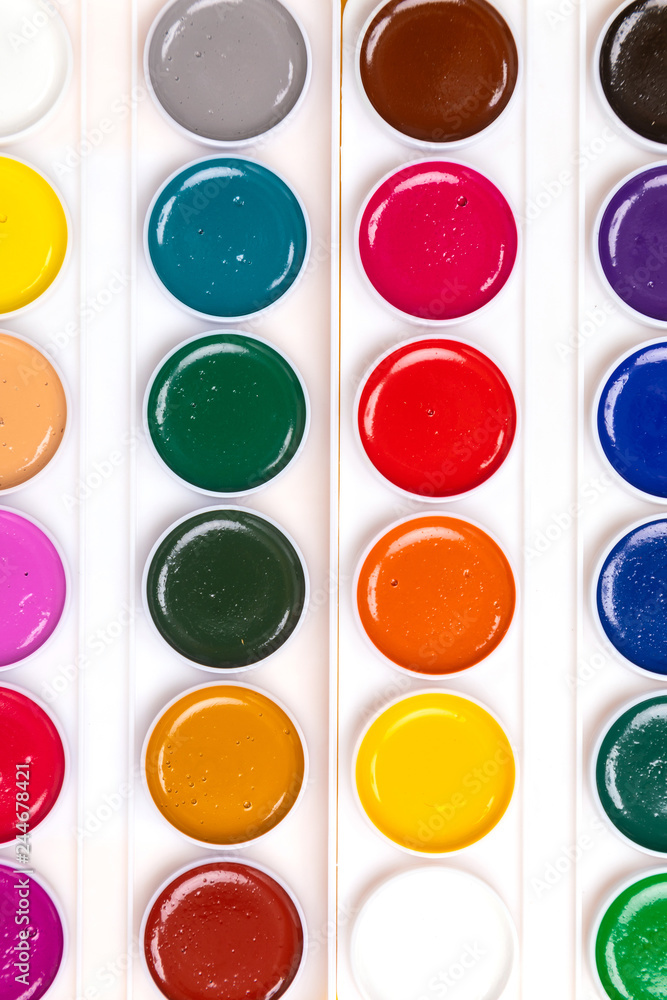 palette with paints close-up lie isolated on yellow background palette with paints close-up lie isolated on yellow background