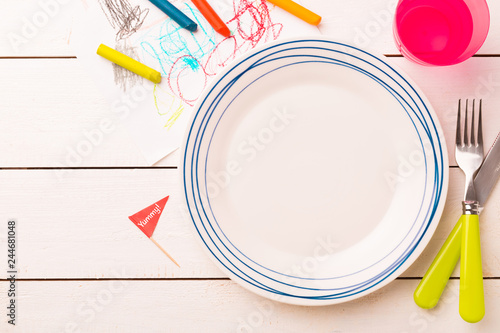 Table setting for kids - empty plate with decorations around