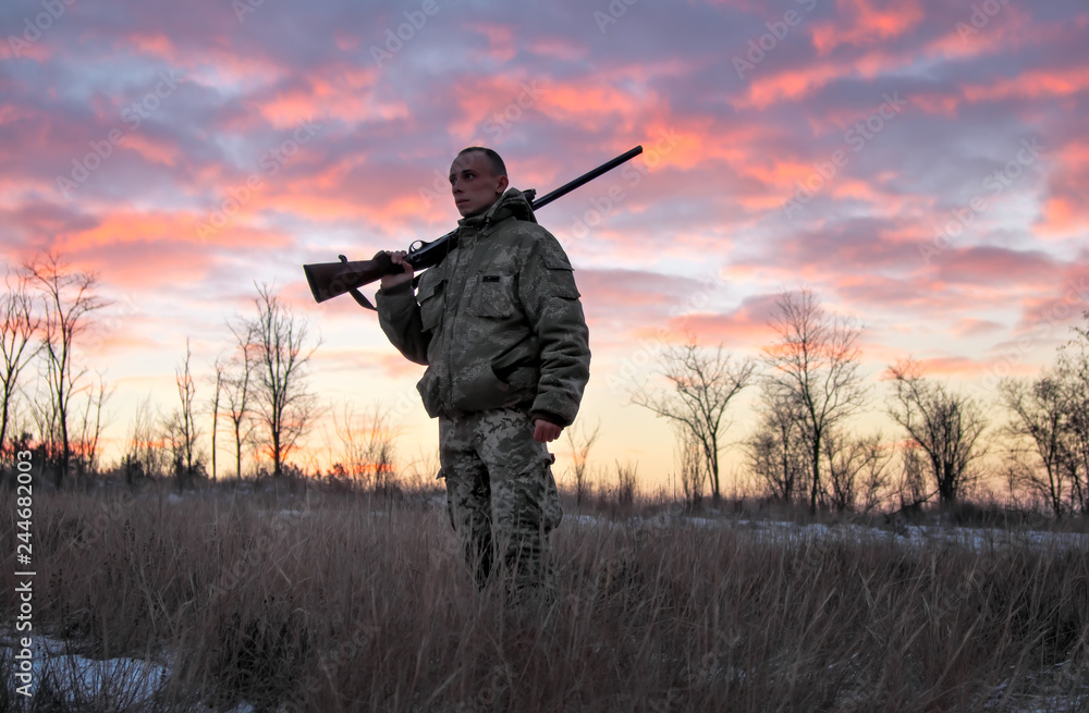 Winter hunting at sunrise. Hunter moving With Shotgun and Looking For Prey. Winter hunting at sunrise. Hunter moving With Shotgun and Looking For Prey.