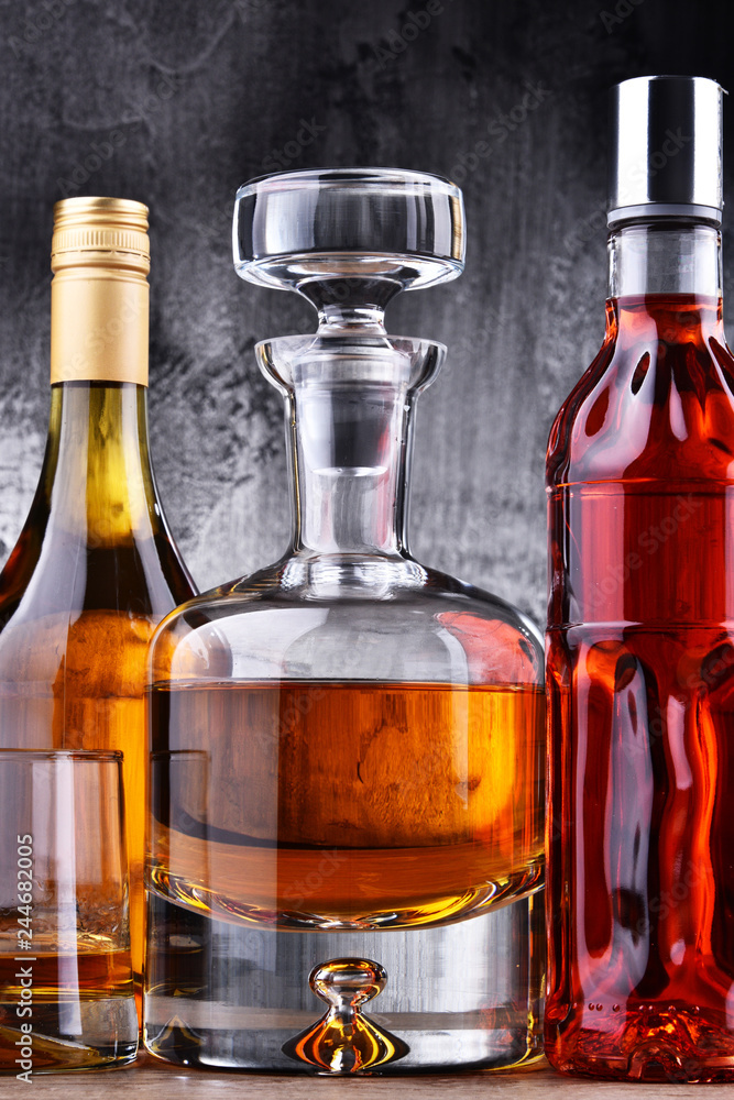 Carafe and bottles of assorted alcoholic beverages. Carafe and bottles of assorted alcoholic beverages.