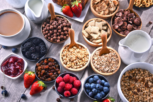 Different sorts of breakfast cereal products and fresh fruits