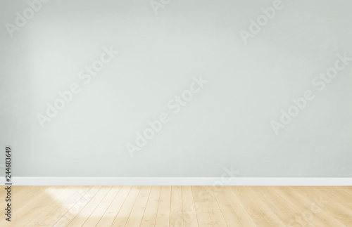 Light green wall in an empty room with a wooden floor photo