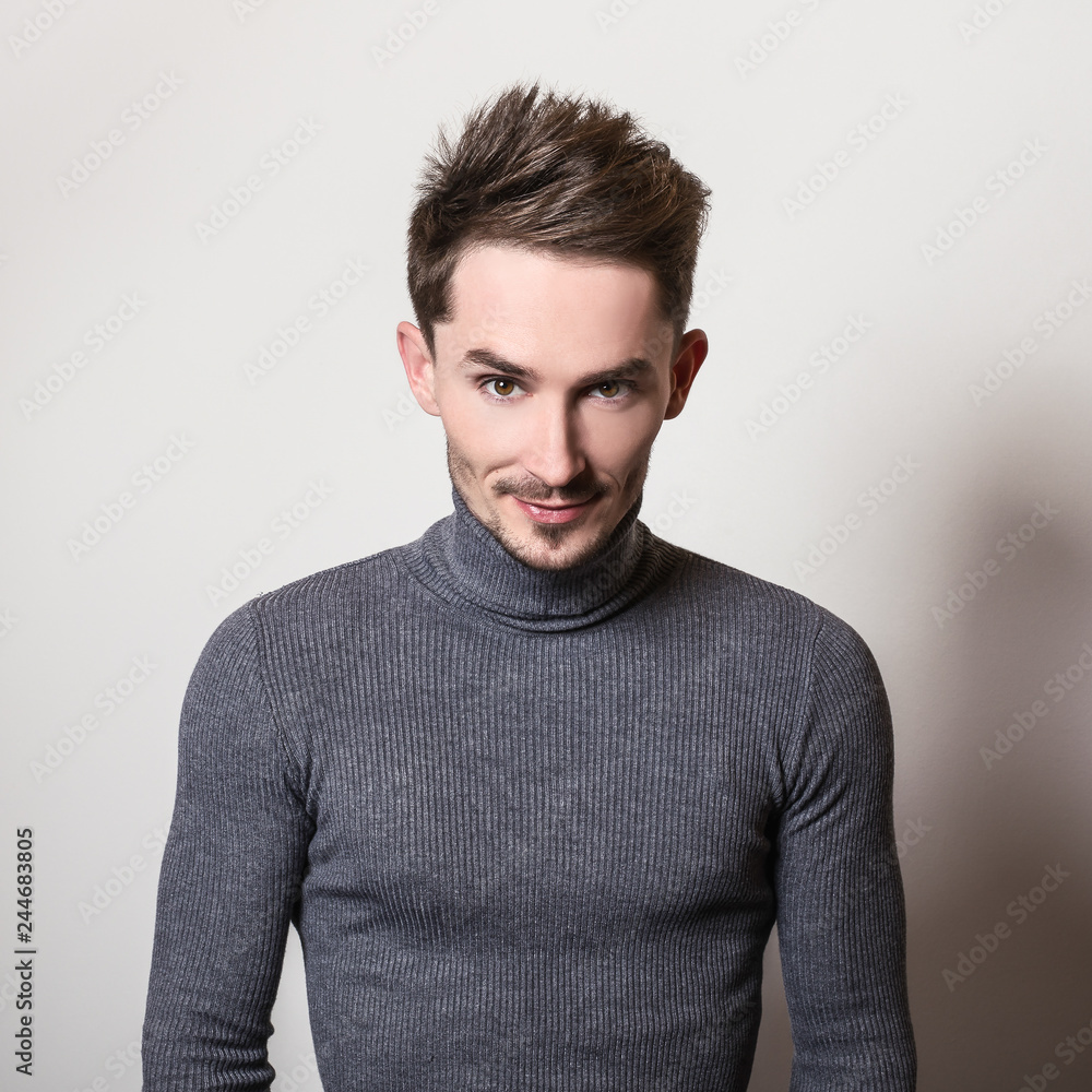 Fototapeta premium Handsome young elegant man in grey golf.