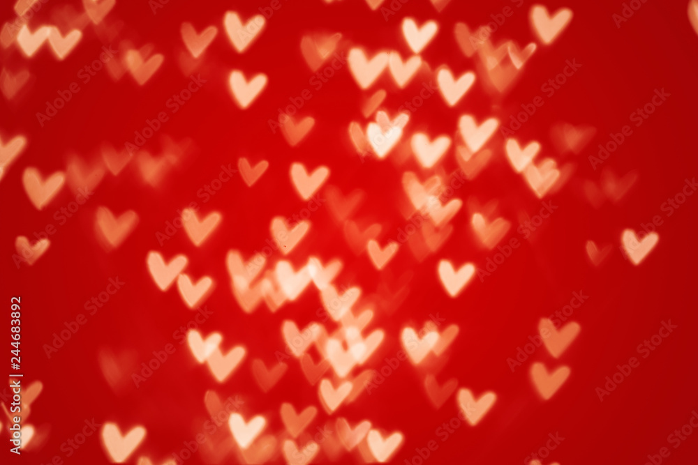 Valentine heart bokeh lights against a red background Valentine heart bokeh lights against a red background