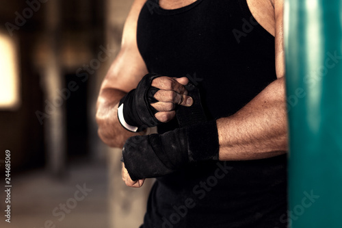 Male boxer punching a boxing bag in warehouse. © Zoran Zeremski