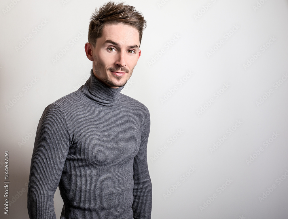 Fototapeta premium Handsome young elegant man in grey golf.