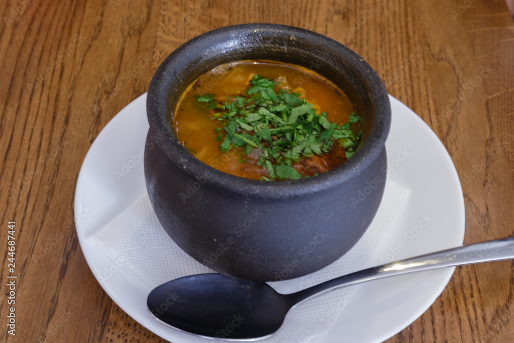 Traditional Georgian soup Kharcho with meat and rice in a pot Traditional Georgian soup Kharcho with meat and rice in a pot