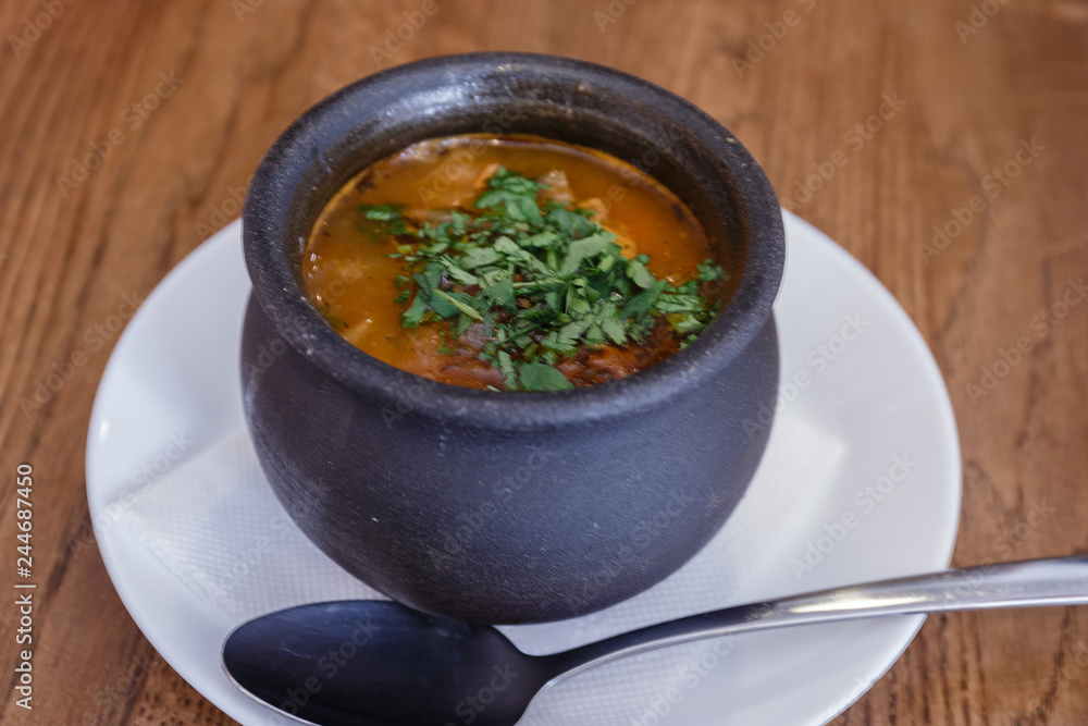 Traditional Georgian soup Kharcho with meat and rice in a pot Traditional Georgian soup Kharcho with meat and rice in a pot
